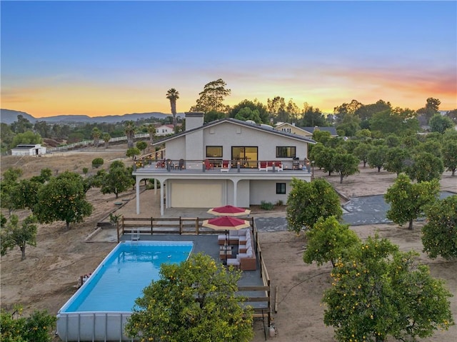33851 Madera De Playa, Temecula, CA 92592 - back of property with a balcony, an outdoor pool, and a mountain view