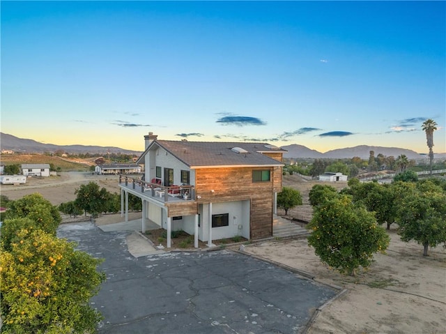 33851 Madera De Playa, Temecula, CA 92592 - back of house at dusk featuring a deck with mountain view