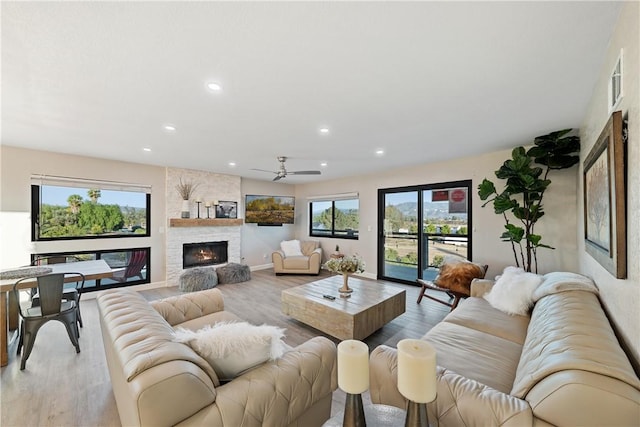 33851 Madera De Playa, Temecula, CA 92592 - living room featuring wood finished floors, a stone fireplace, a ceiling fan, and recessed lighting