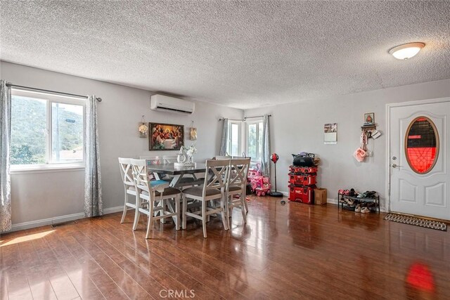 1996 Rainbow Glen Rd, Fallbrook, CA 92028 - dining room featuring a wall mounted AC, wood finished floors, and a textured ceiling