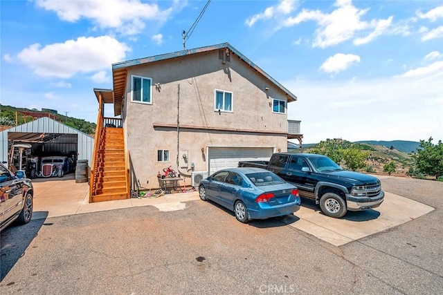 1996 Rainbow Glen Rd, Fallbrook, CA 92028 - view of side of home featuring stairway, driveway, and stucco siding