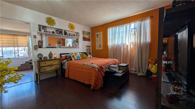 522 S 5th St, Montebello, CA 90640 - bedroom with dark wood-style flooring and a textured ceiling