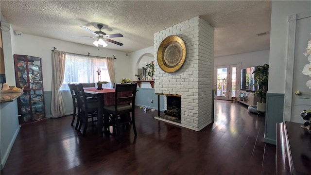 522 S 5th St, Montebello, CA 90640 - dining space featuring a ceiling fan, a textured ceiling, plenty of natural light, wood finished floors, and a brick fireplace
