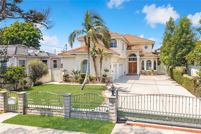405 El Monte St, San Gabriel, CA 91776 - mediterranean / spanish house featuring a gate, concrete driveway, stucco siding, and a fenced front yard