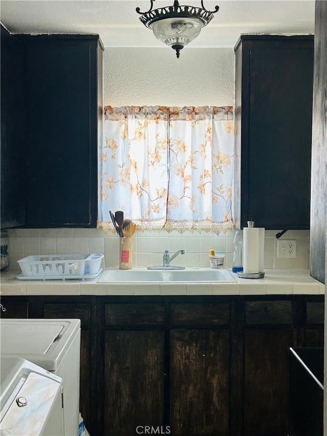3700 W 105th St, Inglewood, CA 90303 - kitchen with decorative backsplash, tile countertops, and washer / clothes dryer