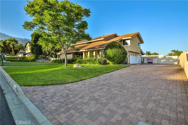 6073 Cameo St, Rancho Cucamonga, CA 91701 - view of property hidden behind natural elements with an attached garage, decorative driveway, a front lawn, and stucco siding
