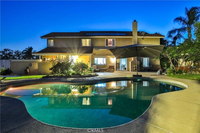 6073 Cameo St, Rancho Cucamonga, CA 91701 - rear view of property featuring a patio area, solar panels, stucco siding, an outdoor pool, and a chimney