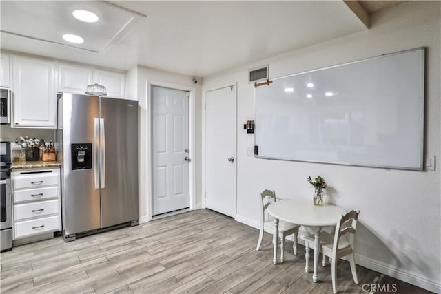 6073 Cameo St, Rancho Cucamonga, CA 91701 - kitchen featuring appliances with stainless steel finishes, light wood-style flooring, white cabinets, and light stone countertops