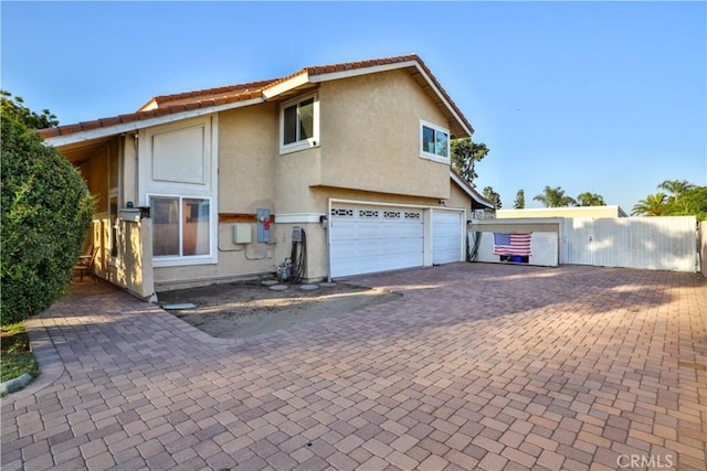 6073 Cameo St, Rancho Cucamonga, CA 91701 - view of front of house featuring an attached garage, stucco siding, and decorative driveway