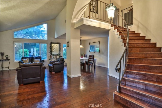 6073 Cameo St, Rancho Cucamonga, CA 91701 - living room featuring high vaulted ceiling, stairs, hardwood / wood-style flooring, and a textured ceiling
