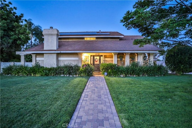6073 Cameo St, Rancho Cucamonga, CA 91701 - view of front of home featuring stucco siding, solar panels, a chimney, a front yard, and a tile roof