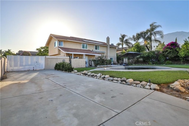 6073 Cameo St, Rancho Cucamonga, CA 91701 - traditional-style house with stucco siding, a gate, roof mounted solar panels, and a swimming pool