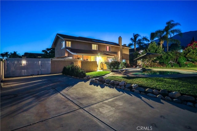 6073 Cameo St, Rancho Cucamonga, CA 91701 - traditional-style home featuring stucco siding, roof mounted solar panels, an outdoor pool, a chimney, and a patio area