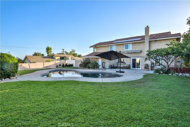 6073 Cameo St, Rancho Cucamonga, CA 91701 - rear view of property with stucco siding, roof mounted solar panels, a chimney, a fenced backyard, and a patio area