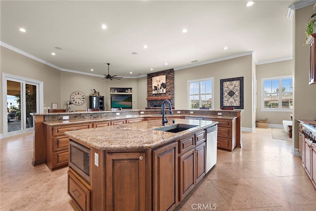 38150 Via Huerta, Murrieta, CA 92562 - kitchen with a large island with sink, appliances with stainless steel finishes, a fireplace, recessed lighting, and ornamental molding