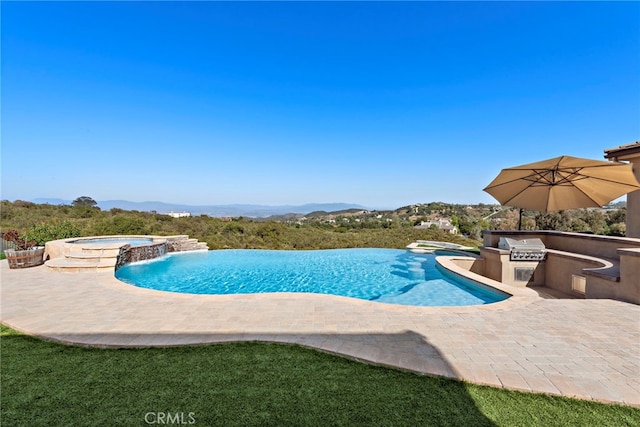 38150 Via Huerta, Murrieta, CA 92562 - view of pool featuring exterior kitchen, a pool with connected hot tub, a patio area, and a mountain view