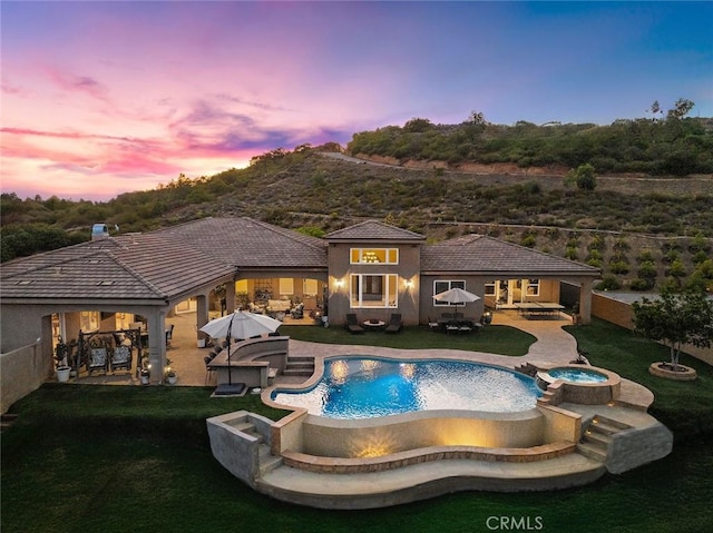 38150 Via Huerta, Murrieta, CA 92562 - view of swimming pool featuring a fire pit, a pool with connected hot tub, a patio, and a lawn