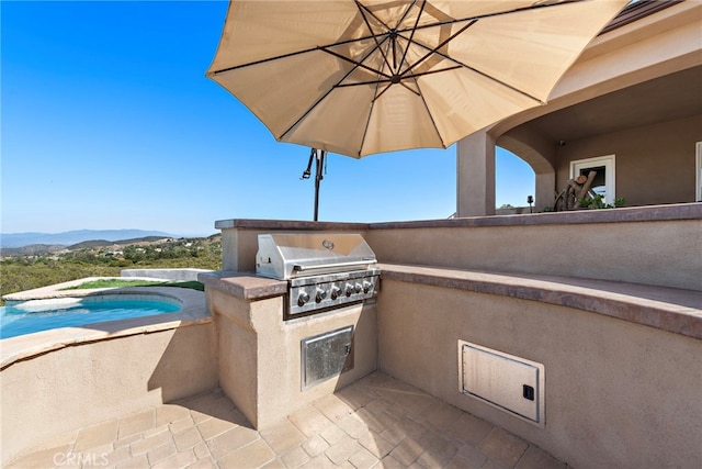 38150 Via Huerta, Murrieta, CA 92562 - view of patio / terrace featuring exterior kitchen, a mountain view, and a pool