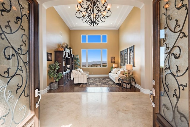 38150 Via Huerta, Murrieta, CA 92562 - foyer entrance with arched walkways, a high ceiling, a chandelier, wood finished floors, and recessed lighting