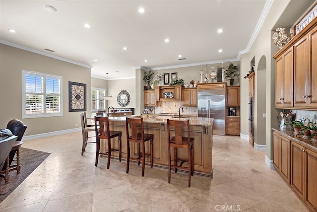 38150 Via Huerta, Murrieta, CA 92562 - kitchen with stainless steel built in fridge, decorative backsplash, a large island with sink, crown molding, and recessed lighting