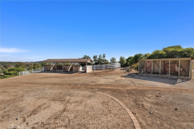 38150 Via Huerta, Murrieta, CA 92562 - view of yard with a carport, a sunroom, an exterior structure, and an outbuilding