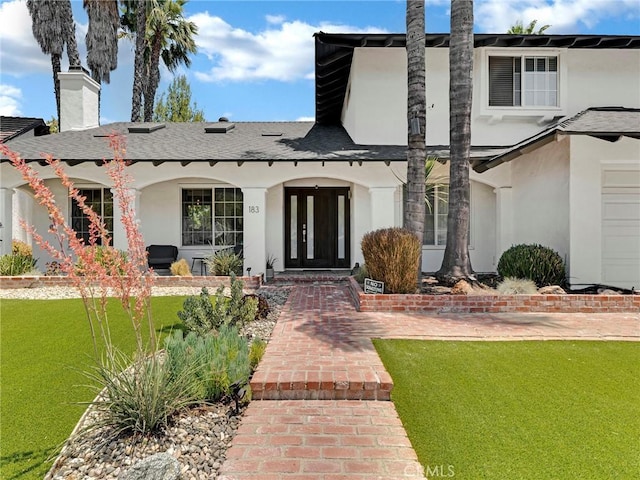 183 W Sidlee St, Thousand Oaks, CA 91360 - view of front of property featuring stucco siding, a chimney, a front lawn, covered porch, and roof with shingles