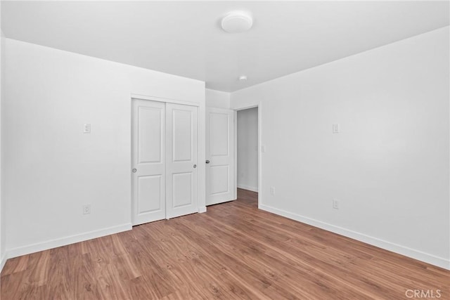 715 N 3rd St, Lompoc, CA 93436 - unfurnished bedroom with light wood-style floors and a closet
