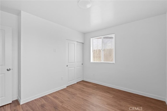 715 N 3rd St, Lompoc, CA 93436 - unfurnished bedroom with wood finished floors and a closet