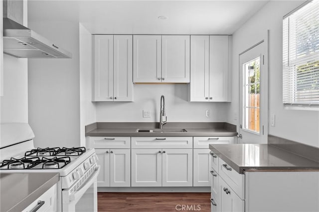 715 N 3rd St, Lompoc, CA 93436 - kitchen featuring wall chimney exhaust hood, white cabinetry, and white gas range oven