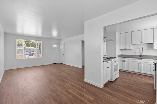715 N 3rd St, Lompoc, CA 93436 - kitchen featuring white range with gas cooktop, white cabinetry, dark wood finished floors, under cabinet range hood, and open floor plan
