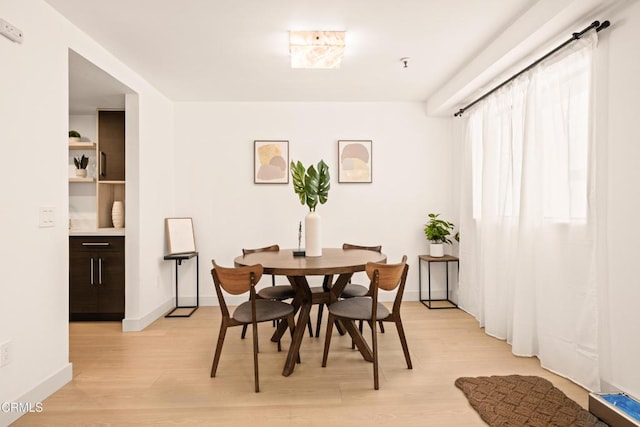 70 N Catalina Ave Unit 101, Pasadena, CA 91106 - dining room featuring light wood-style flooring and baseboards