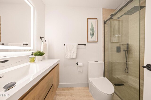 70 N Catalina Ave Unit 101, Pasadena, CA 91106 - bathroom featuring vanity, a stall shower, and wood finished floors