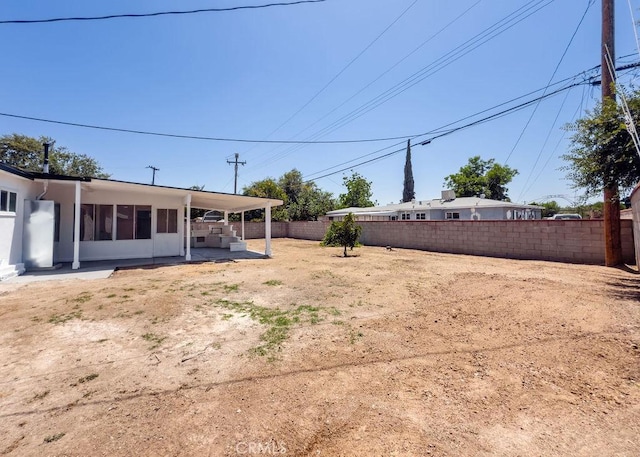 6692 Elm Ave, San Bernardino, CA 92404 - fenced backyard featuring a patio area