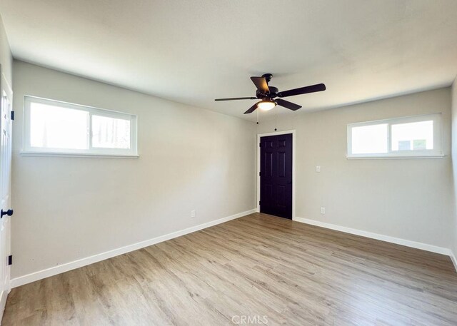 6692 Elm Ave, San Bernardino, CA 92404 - empty room with wood finished floors, plenty of natural light, and a ceiling fan