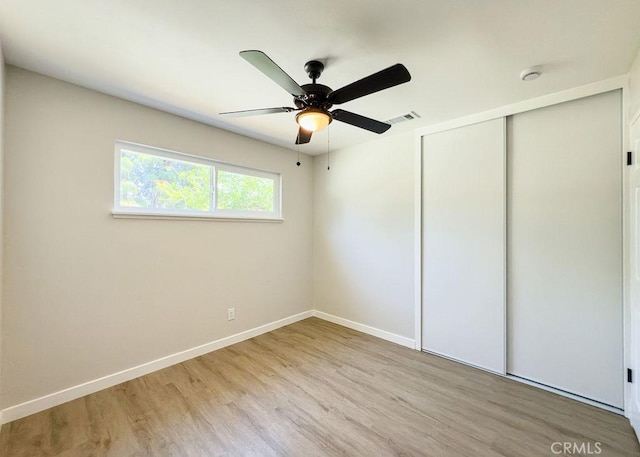 6692 Elm Ave, San Bernardino, CA 92404 - unfurnished bedroom with wood finished floors, a closet, and a ceiling fan