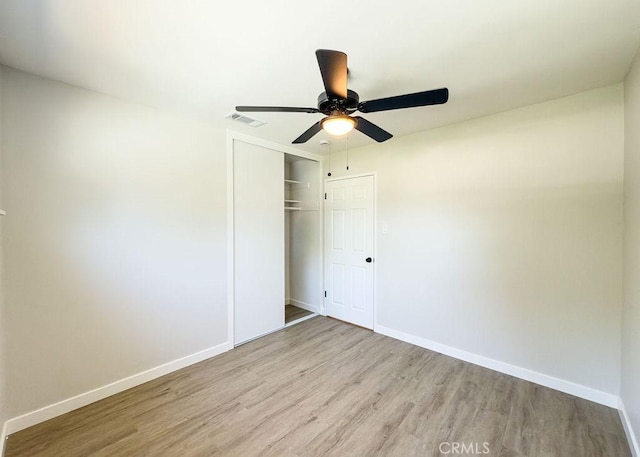 6692 Elm Ave, San Bernardino, CA 92404 - unfurnished bedroom with wood finished floors, a closet, and a ceiling fan