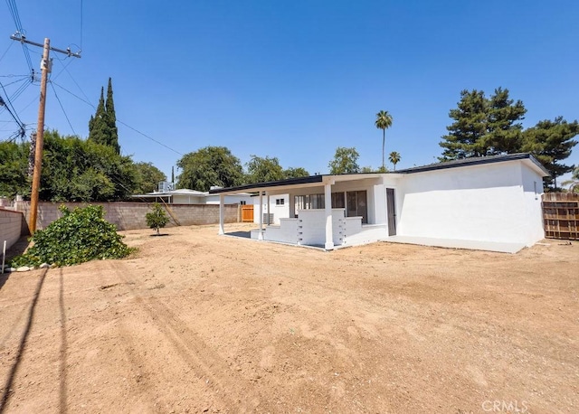 6692 Elm Ave, San Bernardino, CA 92404 - rear view of property with a fenced backyard, a patio, and stucco siding