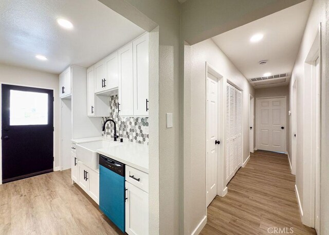 6692 Elm Ave, San Bernardino, CA 92404 - kitchen featuring dishwasher, light wood finished floors, white cabinets, light countertops, and recessed lighting