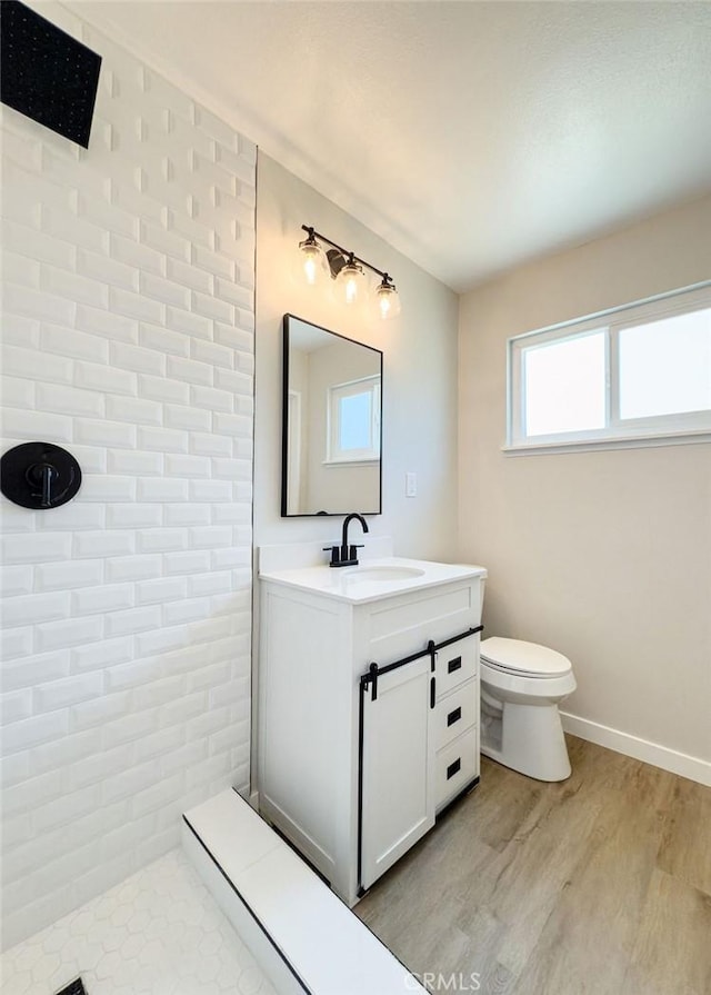6692 Elm Ave, San Bernardino, CA 92404 - bathroom with vanity, tiled shower, and wood finished floors