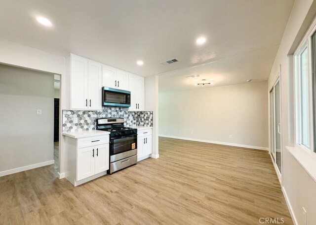 6692 Elm Ave, San Bernardino, CA 92404 - kitchen with stainless steel appliances, backsplash, light countertops, light wood finished floors, and recessed lighting