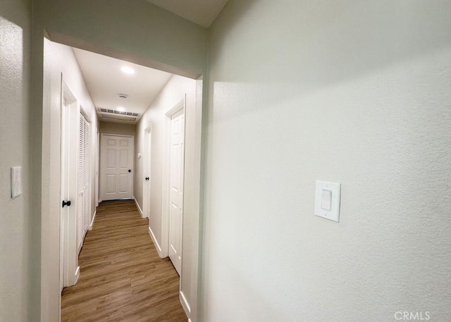 6692 Elm Ave, San Bernardino, CA 92404 - hallway featuring wood finished floors and baseboards