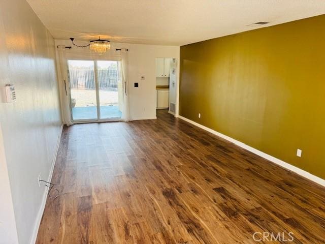98 Lori Way, Banning, CA 92220 - unfurnished room featuring dark wood-style floors and a chandelier
