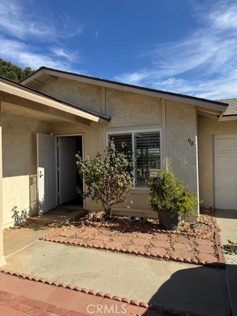 98 Lori Way, Banning, CA 92220 - entrance to property featuring stucco siding and a garage