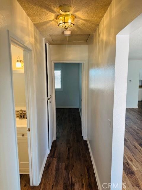 98 Lori Way, Banning, CA 92220 - hallway featuring attic access and dark wood-type flooring