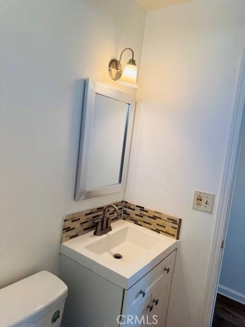 98 Lori Way, Banning, CA 92220 - half bathroom with vanity and tasteful backsplash
