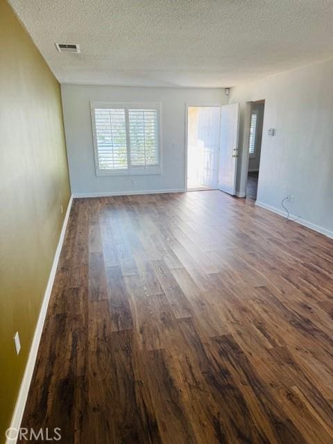 98 Lori Way, Banning, CA 92220 - spare room featuring dark wood-type flooring and a textured ceiling