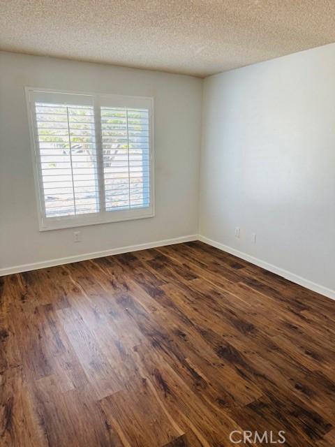 98 Lori Way, Banning, CA 92220 - spare room with dark wood finished floors and a textured ceiling
