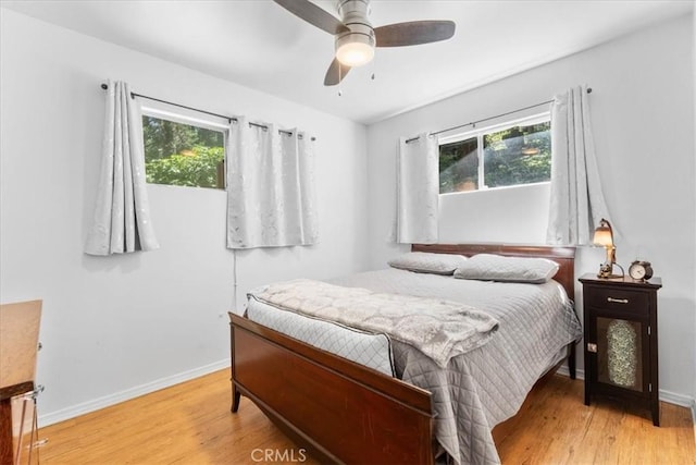 23717 Scenic Dr, Crestline, CA 92325 - bedroom with multiple windows, light wood finished floors, and a ceiling fan