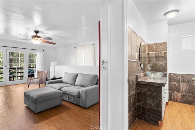 23717 Scenic Dr, Crestline, CA 92325 - living room featuring ceiling fan, wood finished floors, and tile walls