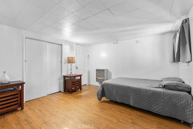 23717 Scenic Dr, Crestline, CA 92325 - bedroom with wood finished floors, heating unit, and a closet